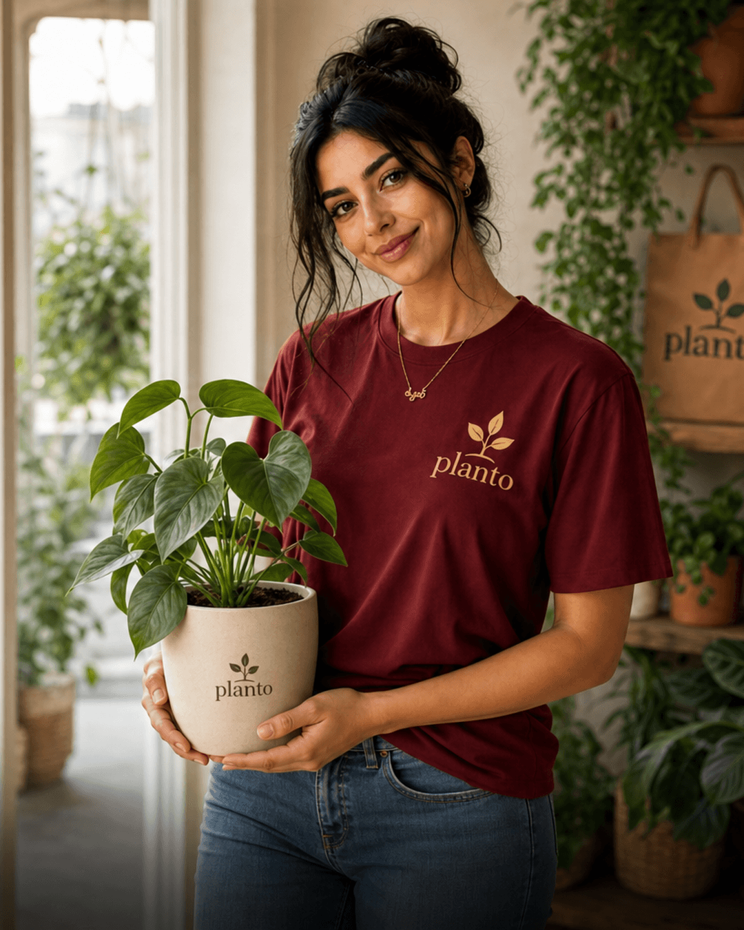 Planto team member holding a potted plant in a bright UAE plant shop